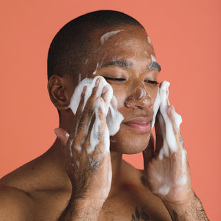 Man applying luxrious foam of natural foaming face wash